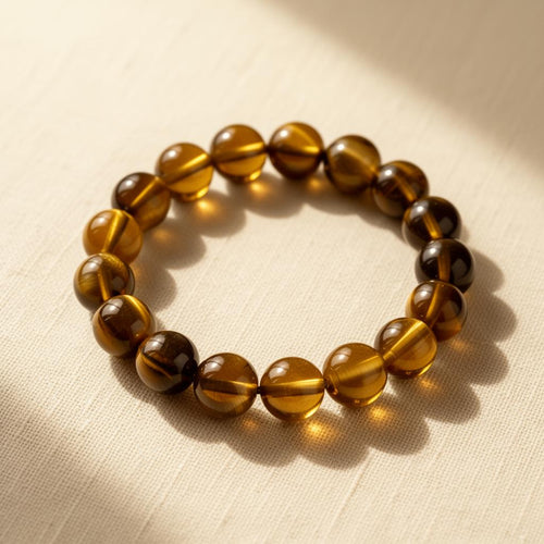 Natural Grade A Tiger's Eye 12mm round bead bracelet showing chatoyancy